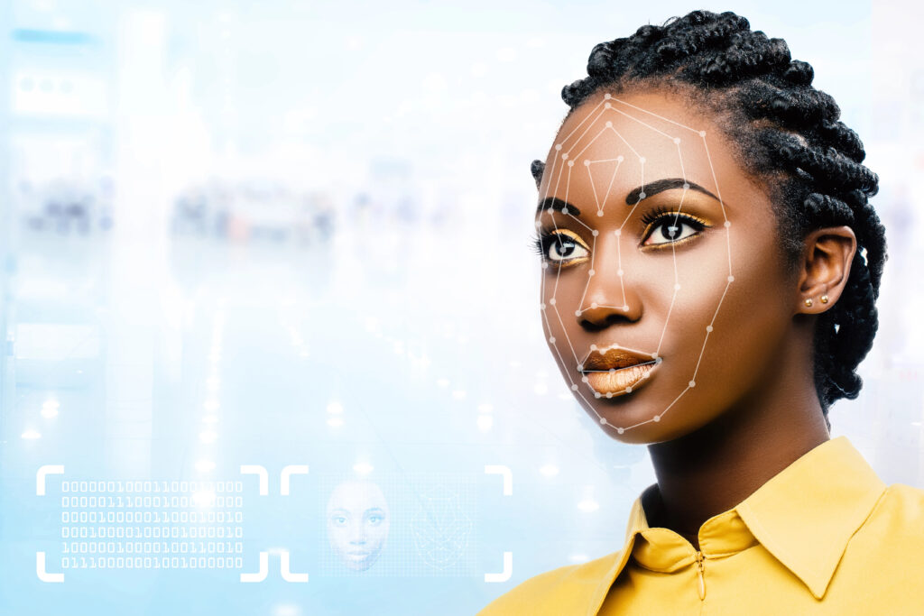 Black woman demonstrating facial recognition scan.