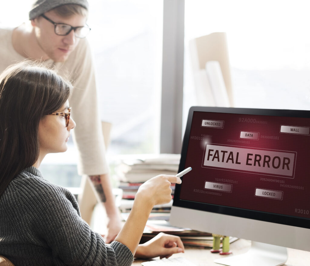 People looking on a computer screen displaying the words "Fatal Error". AI-powered tools fail