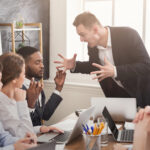 Angry business man yelling at coworking. DEI Backlash